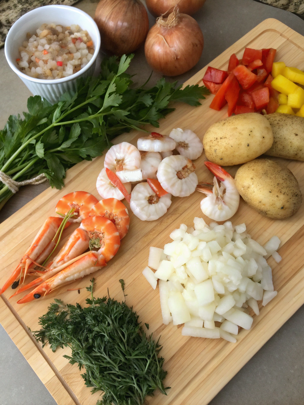 Colorful assortment of fresh seafood, vegetables, and seasonings for seafood casserole